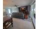 Open-concept living room with a large leather sofa, entertainment center and view of the outdoor patio at 744 Jungle Queen Way, Longboat Key, FL 34228