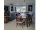 Open-concept living room showcasing a wooden dining set with comfortable lounge area and view to the back yard at 744 Jungle Queen Way, Longboat Key, FL 34228