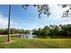 Serene pond with a fountain, surrounded by lush landscaping at 744 Jungle Queen Way, Longboat Key, FL 34228