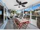 Screened porch with table and chairs, canal view at 744 Jungle Queen Way, Longboat Key, FL 34228