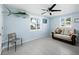 Cozy sitting room with a comfy couch and ceiling fan at 744 Jungle Queen Way, Longboat Key, FL 34228
