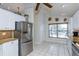 Kitchen with stainless steel appliances and white cabinets at 8049 Hutchinson Dr, New Port Richey, FL 34653