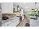 Modern kitchen features stainless steel appliances and granite countertops at 805 Callista Cay Loop, Tarpon Springs, FL 34689