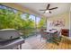 Enjoy outdoor dining on this screened balcony, complete with a grill and tranquil wooded views at 805 Callista Cay Loop, Tarpon Springs, FL 34689