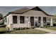 Exterior view of a modern white bungalow with black trim and landscaping at 1023 E 22Nd Ave, Tampa, FL 33605