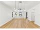 Bright and open living room with hardwood floors, modern lighting, and black framed windows at 1023 E 22Nd Ave, Tampa, FL 33605