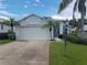 Single-story house with a two-car garage and landscaped yard at 11347 Hollander Ave, Hudson, FL 34667