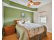 Green bedroom with wooden furniture, ceiling fan, and window with blinds at 11605 Gulf Blvd # 501, Treasure Island, FL 33706