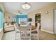 Dining area with white table and chairs, ceiling fan, and view of the bedroom at 11605 Gulf Blvd # 501, Treasure Island, FL 33706