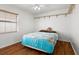 Bedroom with wood-look flooring, ceiling fan, and built-in shelving at 11902 Snapdragon Rd, Tampa, FL 33635