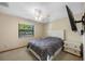 Bedroom featuring a bed, nightstand, and wall-mounted TV at 1304 N Jasmine Ave, Tarpon Springs, FL 34689