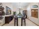 Dining area with a dark wood table, white chairs, and decorative wall art at 1304 N Jasmine Ave, Tarpon Springs, FL 34689