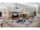 Living room with fireplace, ceiling fan, and plush seating at 1304 N Jasmine Ave, Tarpon Springs, FL 34689