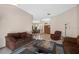 Living room with brown furniture and view into the dining room and foyer at 1304 N Jasmine Ave, Tarpon Springs, FL 34689