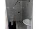 Bathroom with gray marble tile, white pedestal sink, toilet, and shower at 1386 19Th St, Sarasota, FL 34234