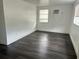 Bright room with dark wood-look laminate flooring and white walls at 1386 19Th St, Sarasota, FL 34234