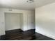 White room with dark wood-look laminate floors and a closet at 1386 19Th St, Sarasota, FL 34234