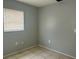 Empty bedroom corner with gray walls, tiled floor, window and blinds at 1386 19Th St, Sarasota, FL 34234