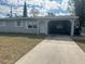 Single-story home with attached carport and driveway at 1386 19Th St, Sarasota, FL 34234