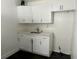 Compact kitchen featuring white shaker cabinets, light countertops, and stainless steel sink and faucet at 1386 19Th St, Sarasota, FL 34234