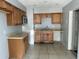 A kitchen featuring wood cabinets, tile floors, and a stainless steel microwave at 1386 19Th St, Sarasota, FL 34234