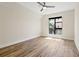 Empty bedroom ready for staging with wood floors, large window, and neutral walls at 199 Dali Blvd # 302, St Petersburg, FL 33701