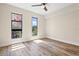 Bright, airy bedroom with wood floors and large windows showcasing city views at 199 Dali Blvd # 302, St Petersburg, FL 33701