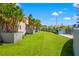 Lush green dog park with planters, benches, and a gated entrance at 199 Dali Blvd # 302, St Petersburg, FL 33701
