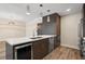 Modern kitchen with island, wine fridge, pendant lights, and stainless steel appliances at 199 Dali Blvd # 302, St Petersburg, FL 33701