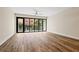 Spacious living room featuring large windows and wood-style flooring at 199 Dali Blvd # 302, St Petersburg, FL 33701