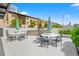 Outdoor grilling area with tables, chairs, and umbrellas at 199 Dali Blvd # 302, St Petersburg, FL 33701