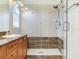 Bathroom with shower, vanity with granite countertop, and wooden cabinets at 2606 Espana Ct, Tampa, FL 33609