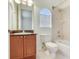 Bathroom featuring a toilet, vanity, and shower/tub combo at 2606 Espana Ct, Tampa, FL 33609