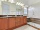 Bathroom featuring double vanities, granite countertop, glass shower at 2606 Espana Ct, Tampa, FL 33609