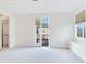 Bright, spacious bedroom with French doors leading to balcony and built-in window seating at 2606 Espana Ct, Tampa, FL 33609