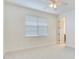 Empty bedroom with window, ceiling fan, and carpeted floor at 2606 Espana Ct, Tampa, FL 33609