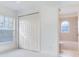 Bright bedroom with double closet doors, ceiling fan, carpeted flooring, and window with blinds at 2606 Espana Ct, Tampa, FL 33609