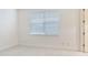 Empty bedroom with large window and light gray carpet at 2606 Espana Ct, Tampa, FL 33609