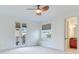 Bright bedroom with ceiling fan, French doors to a balcony, and ensuite bathroom at 2606 Espana Ct, Tampa, FL 33609