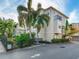 Townhouse with palm trees, shrubs, and black metal fencing at 2606 Espana Ct, Tampa, FL 33609