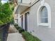 Front walkway of the townhouse with shrubs and a decorated front door at 2606 Espana Ct, Tampa, FL 33609