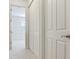 Hallway with white doors and carpeted flooring at 2606 Espana Ct, Tampa, FL 33609