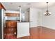 Open kitchen and dining area with wood floors, granite countertops, stainless steel appliances, and a breakfast bar at 2606 Espana Ct, Tampa, FL 33609
