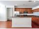 Spacious kitchen featuring wood cabinetry, a pantry, granite countertops, and stainless steel appliances at 2606 Espana Ct, Tampa, FL 33609