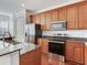 Updated kitchen with granite countertops, stainless steel appliances, wood cabinets, and ample counter space at 2606 Espana Ct, Tampa, FL 33609