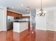 Modern kitchen with stainless steel appliances, wood cabinets, and an island at 2606 Espana Ct, Tampa, FL 33609