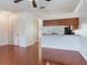Open living space with kitchen featuring hardwood floors, breakfast bar, and white cabinets at 2606 Espana Ct, Tampa, FL 33609