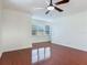 Living room with polished hardwood floors, crown molding, white walls, and large windows at 2606 Espana Ct, Tampa, FL 33609