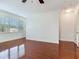 Large open living room with gleaming hardwood floors, high ceilings, and windows at 2606 Espana Ct, Tampa, FL 33609