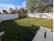 Fenced backyard with a paved patio and grassy area at 27355 Breakers Dr, Wesley Chapel, FL 33544
